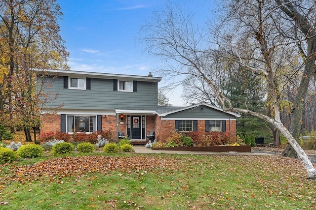 view of front of property with a front yard and brick siding