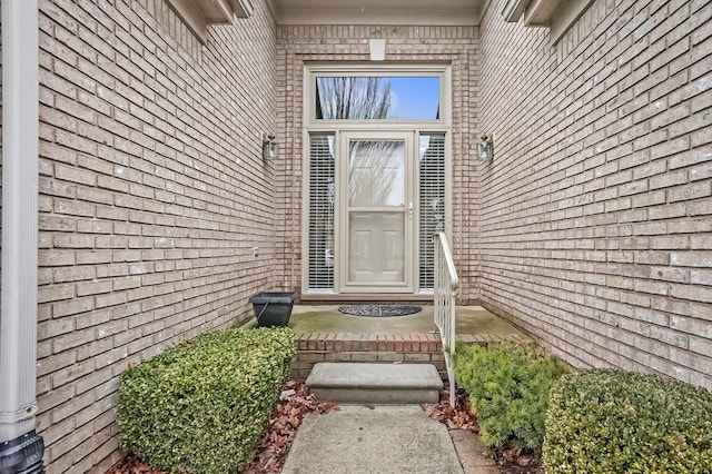 view of exterior entry with brick siding