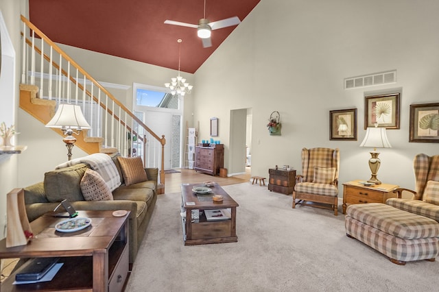 living area with carpet floors, stairs, visible vents, high vaulted ceiling, and ceiling fan with notable chandelier