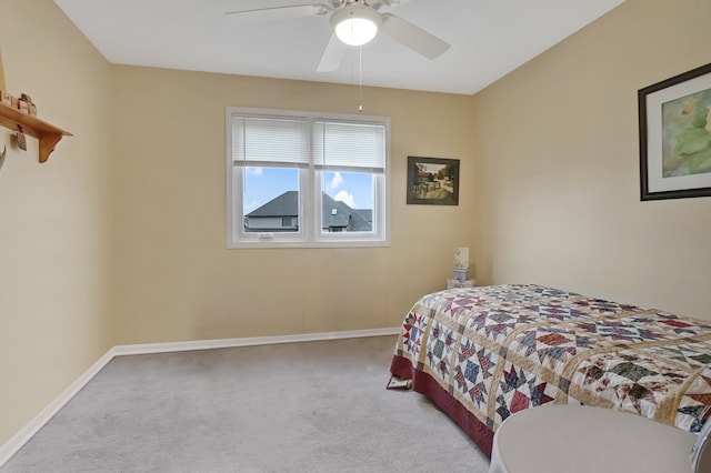 carpeted bedroom with ceiling fan and baseboards