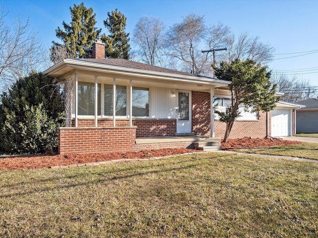 view of front of house with brick siding, a front lawn, concrete driveway, a chimney, and an attached garage