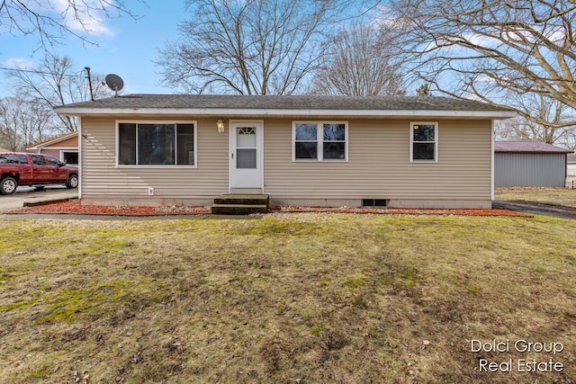 view of front of home with entry steps and a front yard