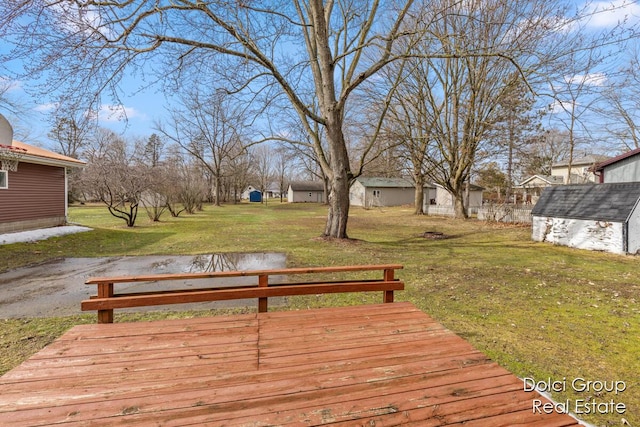 deck featuring a yard, a shed, and an outdoor structure