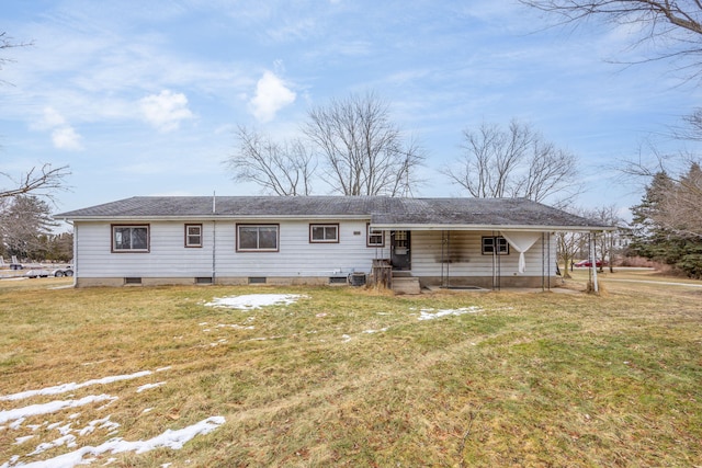 rear view of property featuring a yard