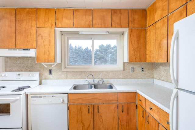 kitchen with light countertops, backsplash, a sink, white appliances, and under cabinet range hood