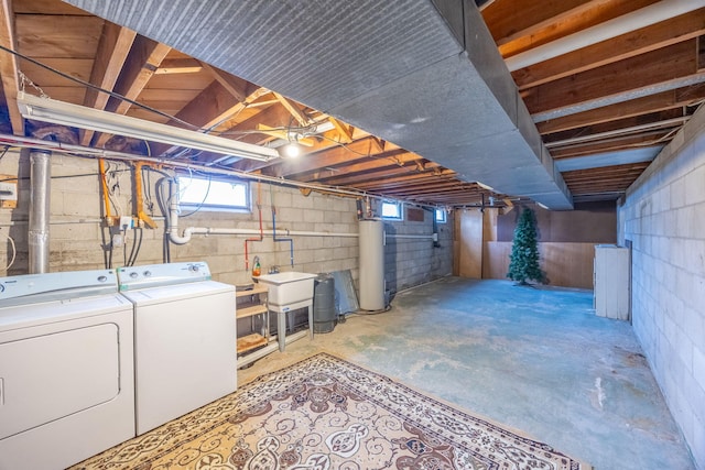 below grade area featuring a sink, separate washer and dryer, and gas water heater