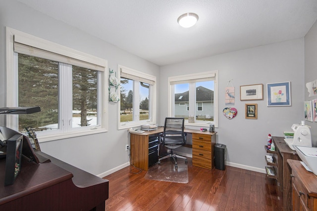 office featuring plenty of natural light, baseboards, and dark wood-type flooring