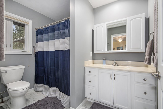 bathroom featuring marble finish floor, vanity, toilet, and baseboards