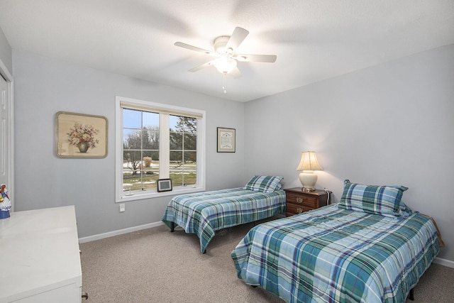 carpeted bedroom with ceiling fan and baseboards