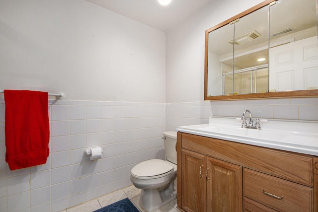 full bath featuring toilet, a shower stall, visible vents, and tile patterned floors