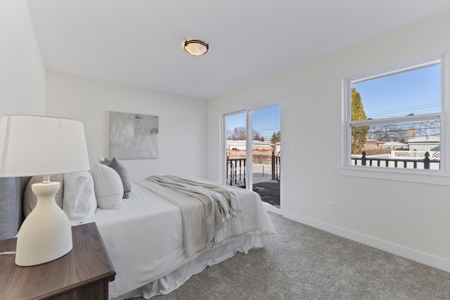 carpeted bedroom featuring access to exterior and baseboards