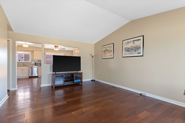 living area featuring ceiling fan, baseboards, vaulted ceiling, and dark wood-style flooring