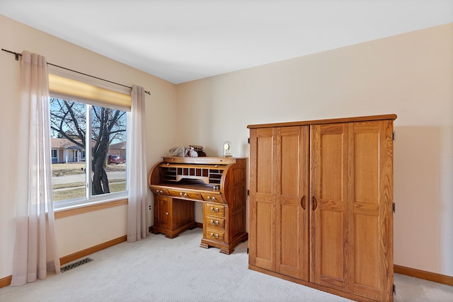 office space with light carpet, visible vents, and baseboards