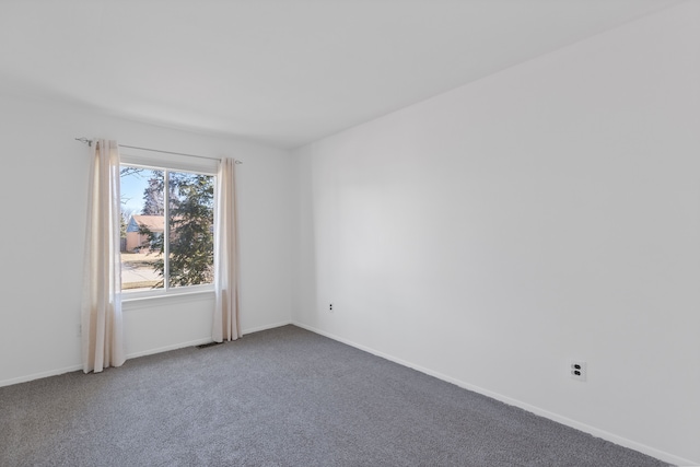 empty room with carpet and baseboards