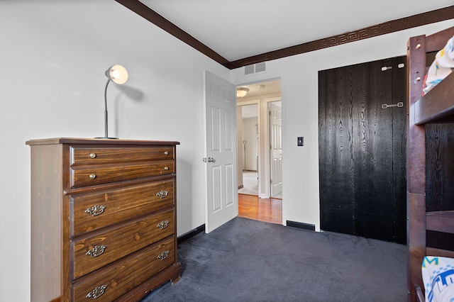 bedroom with carpet floors, visible vents, and baseboards