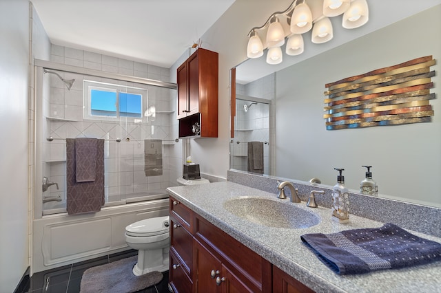 bathroom with vanity, combined bath / shower with glass door, tile patterned flooring, and toilet