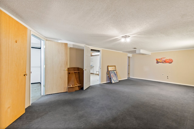 empty room featuring a textured ceiling and dark carpet