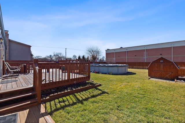 view of yard with a shed, a deck, an outdoor pool, and an outdoor structure