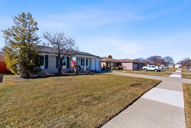 ranch-style home with brick siding, driveway, and a front lawn