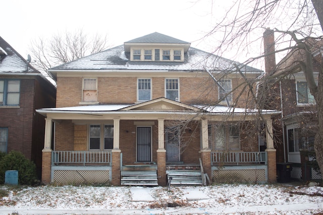 traditional style home with a porch and brick siding