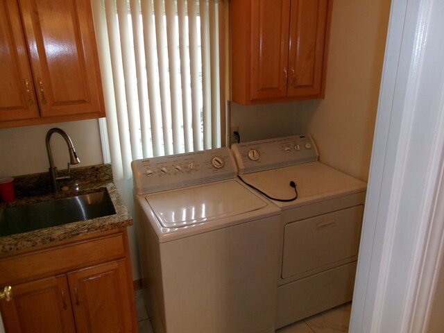 13267 Pearl Dr, Utica, MI 48315 - laundry room featuring light tile patterned flooring, independent washer and dryer, a sink, and cabinet space