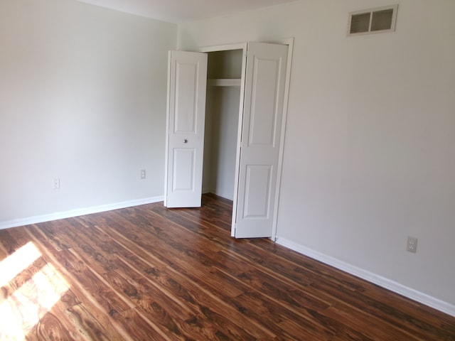13267 Pearl Dr, Utica, MI 48315 - unfurnished bedroom with baseboards, dark wood-style floors, and visible vents