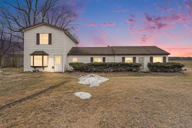 traditional-style home featuring a front yard