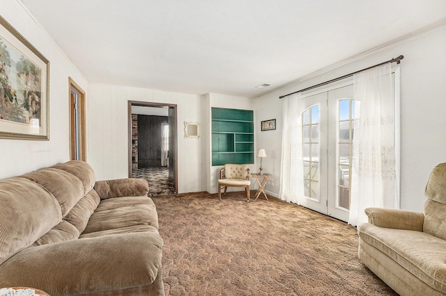 carpeted living area featuring french doors