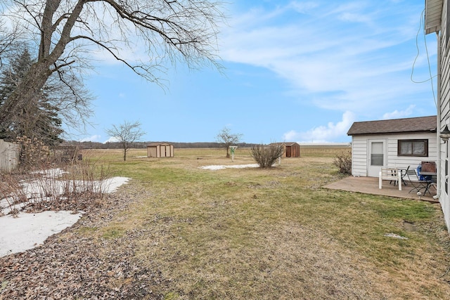 view of yard featuring a deck, a shed, an outdoor structure, and fence