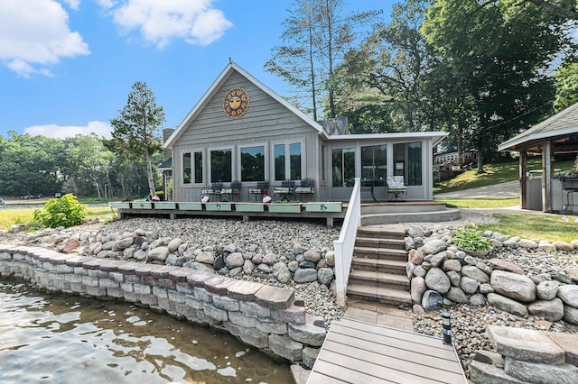 back of house featuring a sunroom and a deck