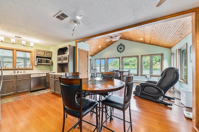 dining area featuring lofted ceiling, visible vents, ceiling fan, and light wood-style flooring