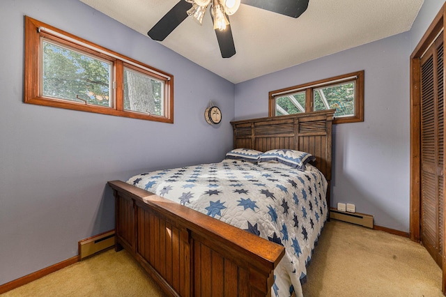 bedroom with light carpet, a baseboard radiator, baseboard heating, and a closet