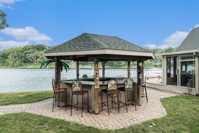 view of patio / terrace featuring a water view and outdoor dry bar