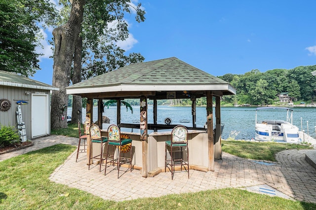 view of patio with a water view, outdoor dry bar, and a gazebo