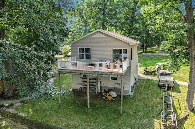 rear view of property with a yard and a wooden deck