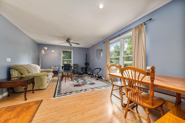 living room with light wood-style flooring and a ceiling fan