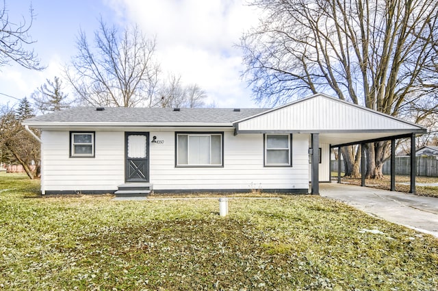 view of front facade with driveway, an attached carport, a front lawn, and roof with shingles