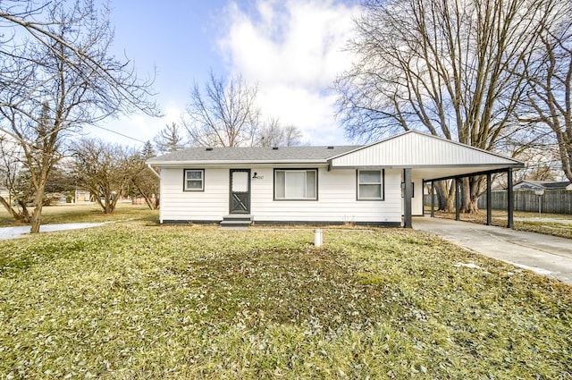 ranch-style house with entry steps, concrete driveway, fence, a front lawn, and a carport