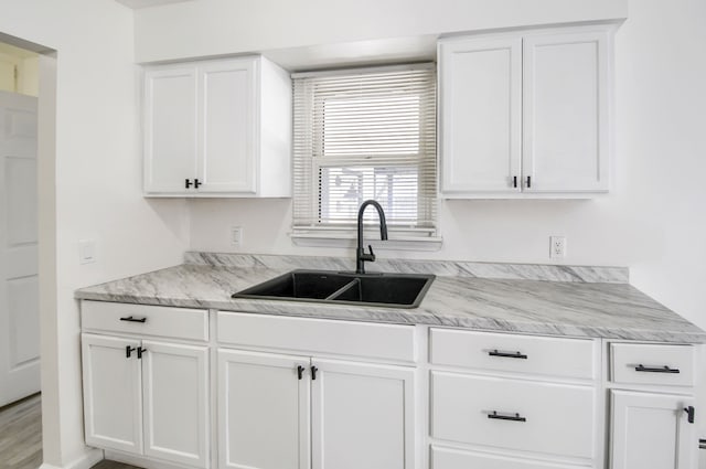 kitchen with white cabinets and a sink