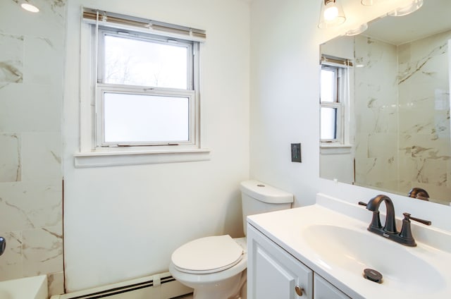 bathroom featuring toilet, a baseboard heating unit, vanity, and a wealth of natural light