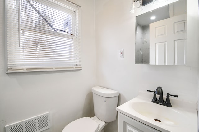 bathroom with visible vents, walk in shower, vanity, and toilet