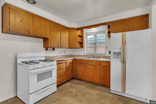 kitchen featuring white appliances, a sink, visible vents, light countertops, and open shelves