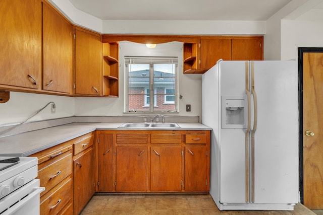 kitchen featuring open shelves, white appliances, a sink, and light countertops