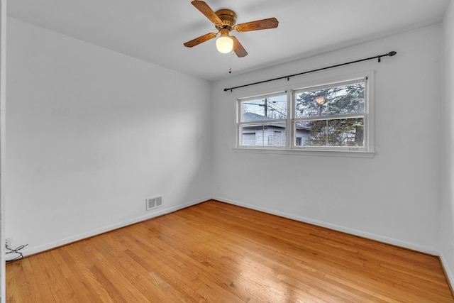 unfurnished room featuring visible vents, a ceiling fan, light wood-style flooring, and baseboards