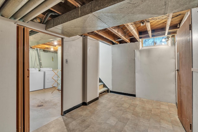 below grade area with stairs, separate washer and dryer, and tile patterned floors