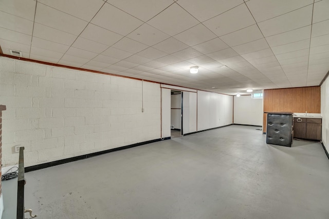 finished basement featuring concrete block wall