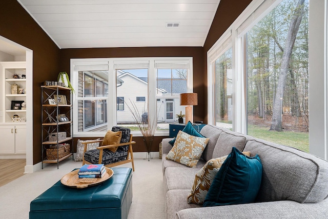 sunroom with lofted ceiling and visible vents