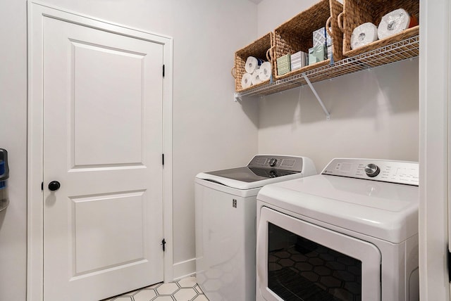 washroom featuring laundry area and separate washer and dryer