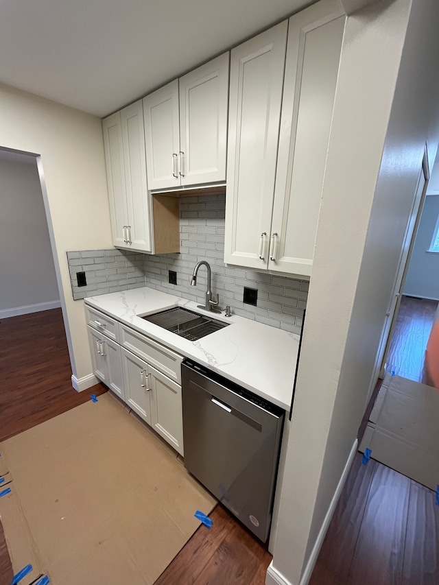 kitchen with tasteful backsplash, white cabinetry, a sink, and stainless steel dishwasher