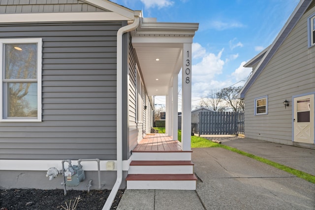 view of side of home featuring fence